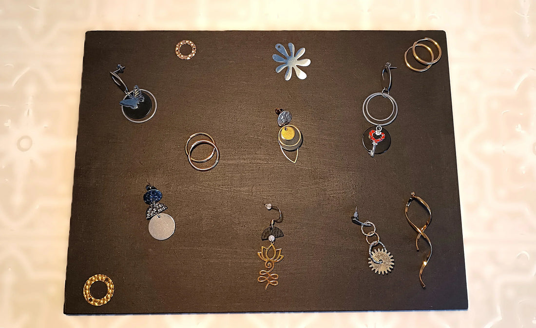 bijoux en acier inoxydable sur une planche de bois noire